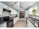 Modern kitchen featuring white cabinets, grey countertops and stainless steel appliances at 18 Pine Circle Dr, Ocala, FL 34472