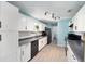 Bright kitchen featuring white cabinets, grey countertops, and stainless steel appliances at 18 Pine Circle Dr, Ocala, FL 34472