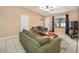 Bright living room featuring neutral walls, tile flooring, and comfortable sofas for relaxing at 18 Pine Circle Dr, Ocala, FL 34472