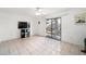 Bright living room featuring a ceiling fan, tile flooring, and sliding glass doors to the backyard at 18 Pine Circle Dr, Ocala, FL 34472