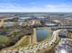 Expansive aerial view of a community with lakes, lush landscaping, and tiled roofs at 760 Pebble Beach Dr, Davenport, FL 33896