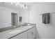 Bright bathroom featuring double sinks, modern fixtures, and stylish vanity at 760 Pebble Beach Dr, Davenport, FL 33896