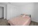 Cozy bedroom with plush carpet and a comfortable-looking pink patterned bed at 760 Pebble Beach Dr, Davenport, FL 33896