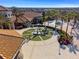 A Gathering enjoying a community fountain area, with pools and clubhouse in the background at 760 Pebble Beach Dr, Davenport, FL 33896