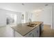 Bright and airy living room with tile floors, sliding glass doors, and modern light fixture at 760 Pebble Beach Dr, Davenport, FL 33896