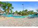 Relaxing pool with chairs and tables surrounded by palm trees and lush landscaping at 760 Pebble Beach Dr, Davenport, FL 33896