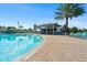 A view of the community poolside bar, pool, and lounge chairs at 760 Pebble Beach Dr, Davenport, FL 33896