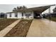Ranch style home with carport and mature landscaping at 1106 Avenue N, Haines City, FL 33844