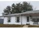 White, ranch-style home with shutters and small front porch at 1106 Avenue N, Haines City, FL 33844