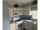 White cabinets, blue countertops, and electric range at 1106 Avenue N, Haines City, FL 33844