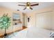 Bedroom with wood floors, ceiling fan, bright wall art and double door closet at 6143 Black Walnut Dr, Bartow, FL 33830