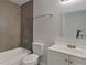 Bright bathroom with a tub shower, white vanity, and neutral-colored wall tiles at 854 4Th St, Winter Haven, FL 33881
