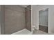 Modern bathroom featuring a stand-up shower with gray tiling and a view into the walk-in closet at 854 4Th St, Winter Haven, FL 33881