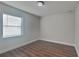 Simple bedroom with wood-look floors and window blinds at 854 4Th St, Winter Haven, FL 33881