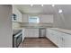 Modern kitchen with white cabinets and granite countertops at 854 4Th St, Winter Haven, FL 33881