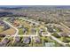 An aerial view of a neighborhood with well-maintained homes and lush greenery at 4079 Grandefield Cir, Mulberry, FL 33860