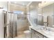 Elegant bathroom featuring a marble countertop, tiled shower with rainfall showerhead and mosaic tile accents at 4079 Grandefield Cir, Mulberry, FL 33860