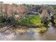 Aerial view of waterfront property featuring a home, dock, and natural landscape at 8309 W Lake Marion Rd, Haines City, FL 33844
