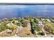 Aerial view of a lakeside home with a large lot, mature trees and direct water access at 8309 W Lake Marion Rd, Haines City, FL 33844