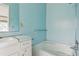 Bathroom featuring a single sink vanity, mirror, and blue walls at 8309 W Lake Marion Rd, Haines City, FL 33844