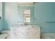 Bathroom with a single sink vanity, mirror, and blue walls at 8309 W Lake Marion Rd, Haines City, FL 33844