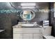 Updated bathroom with a marble countertop vanity and a decorative mirror at 8309 W Lake Marion Rd, Haines City, FL 33844