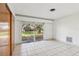 Bright bedroom with tile floor and sliding glass doors to outside at 8309 W Lake Marion Rd, Haines City, FL 33844