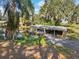 Covered boat dock with boat on the water, surrounded by lush greenery at 8309 W Lake Marion Rd, Haines City, FL 33844