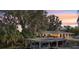 Lakeside home featuring a boat dock, single-story structure, and mature trees draped in Spanish moss at 8309 W Lake Marion Rd, Haines City, FL 33844