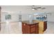 Kitchen featuring an island with seating and ample countertop space, tiled floors at 8309 W Lake Marion Rd, Haines City, FL 33844