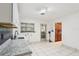 Bright room with tile floor, white cabinets, sink, and doorway to another room at 8309 W Lake Marion Rd, Haines City, FL 33844