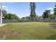 Large grassy backyard with mature trees and privacy fence at 5119 Martinique Dr, Lakeland, FL 33812