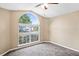 Bedroom with large arched window and neutral carpeting at 5119 Martinique Dr, Lakeland, FL 33812