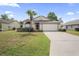 One-story house with attached garage and grassy front yard at 5119 Martinique Dr, Lakeland, FL 33812