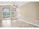 Living room with vaulted ceiling and sliding glass doors to patio at 5119 Martinique Dr, Lakeland, FL 33812