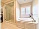 Luxurious bathroom with soaking tub and walk-in shower at 622 Penn Pl, Winter Park, FL 32789