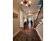 Elegant entryway with hardwood floors, chandelier, and staircase at 622 Penn Pl, Winter Park, FL 32789