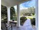 Inviting front porch with stone flooring and view of landscape at 622 Penn Pl, Winter Park, FL 32789