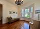 Sunlit sitting room with bay window, hardwood floors, and chaise lounge at 622 Penn Pl, Winter Park, FL 32789