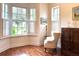 Bright sitting room with hardwood floors, bay window, and comfortable chair at 622 Penn Pl, Winter Park, FL 32789