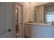 Well-lit bathroom features dual sinks, granite countertops, and white cabinets at 637 Bernard Ln, Davenport, FL 33837