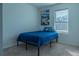 Simple bedroom with carpet flooring and a bed near the natural light from a window at 637 Bernard Ln, Davenport, FL 33837