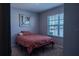 Cozy bedroom featuring carpet flooring, a large window, and a calming color palette at 637 Bernard Ln, Davenport, FL 33837