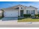 Charming single-story home featuring a two-car garage, well-kept lawn, and a freshly painted exterior at 637 Bernard Ln, Davenport, FL 33837