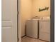 Laundry room with modern washer and dryer, adjacent to a door at 637 Bernard Ln, Davenport, FL 33837