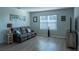 Cozy living room features laminate floors, a neutral color scheme, and plenty of natural light at 637 Bernard Ln, Davenport, FL 33837