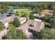 Aerial view of a beautiful home near a golf course and lake, surrounded by lush greenery and other residences at 417 Lake Butler Dr, Kissimmee, FL 34759