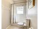 Well-lit bathroom features a shower-tub combination with a curtain and tiled walls at 417 Lake Butler Dr, Kissimmee, FL 34759