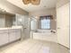 Bright bathroom featuring a soaking tub, glass shower, and double sink vanity at 417 Lake Butler Dr, Kissimmee, FL 34759