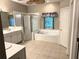 Primary bathroom with a soaking tub, tiled floors, and a walk-in shower at 417 Lake Butler Dr, Kissimmee, FL 34759
